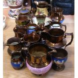 Seventeen various Victorian copper lustre jugs, vases and bowls (17).