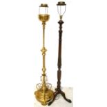 An ornate brass standard lamp with a stem of twist design to a rounded stepped base,