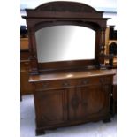 An Art Nouveau oak sideboard of large proportions, top with carved foliate decoration,