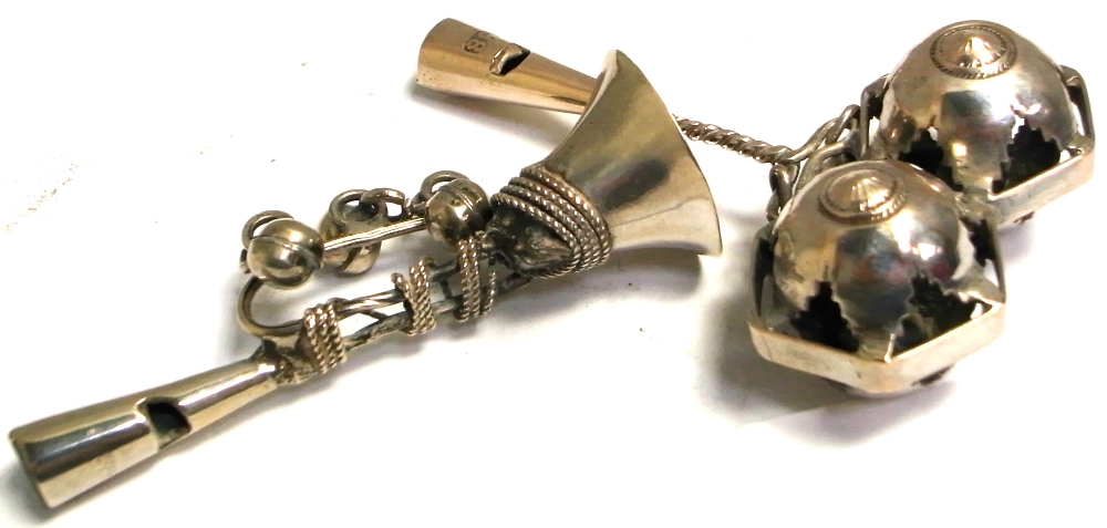 Two silver baby rattles, one in the form of a trumpet and one as jesters bells, both marked 1886,