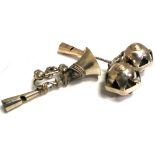 Two silver baby rattles, one in the form of a trumpet and one as jesters bells, both marked 1886,