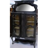 A late 19th early 20th century ebonised twin door display cabinet,