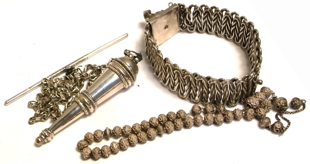 A white metal châtelain on a chain,
