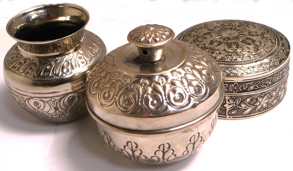 A silver heavily engraved white metal pot, with marks to base,