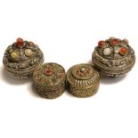 Four white metal trinket pots, various sizes, all set with a variety of hardstones,