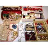 A quantity of costume jewellery to include necklaces, brooches,