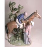 A large Lladro figure, a jockey on a stallion beside a lady holding a parasol,