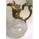 A Continental cut glass claret jug with silver handle and lid,