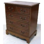 A mahogany and inlaid two over three chest of drawers of small proportions with brass handles on