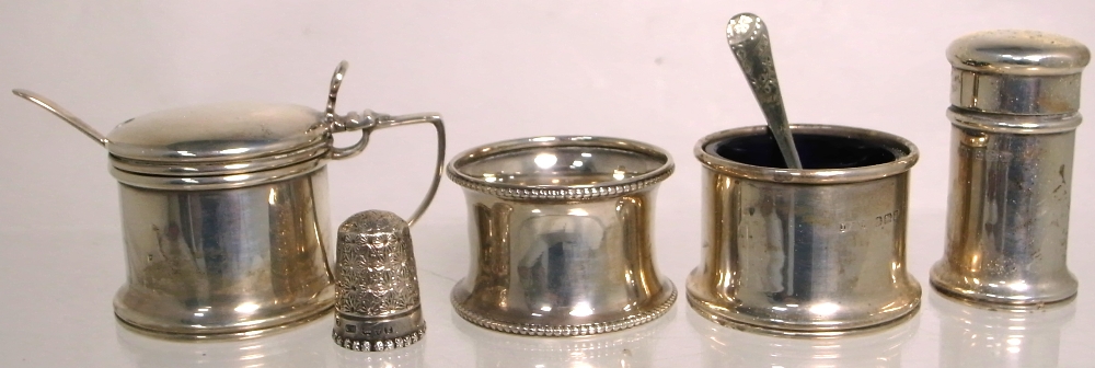 A hallmarked silver salt, mustard, pepper, thimble and napkin ring, various hallmarks (5).