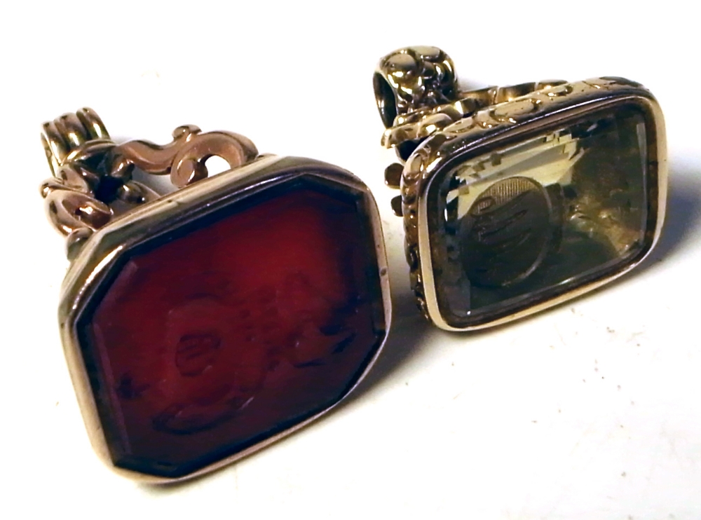Two yellow metal fobs, one with citrine colour stone with intaglio of bird and initials,