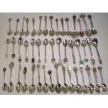 A quantity of hallmarked silver and white metal souvenir spoons, approx combined weight 17ozt.