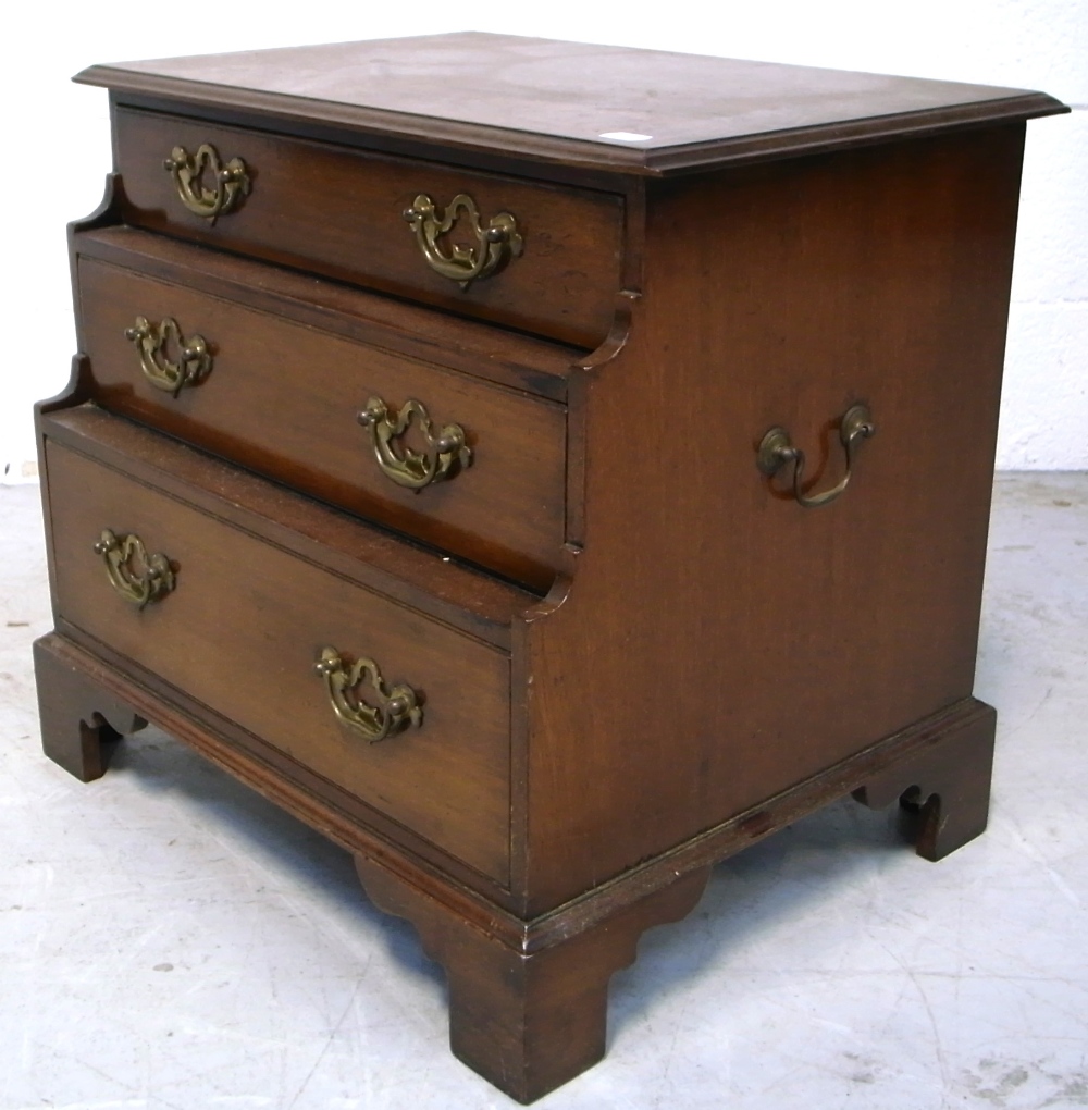 A late 19th early 20th century oak three drawer chest of drawers of stepped design and small