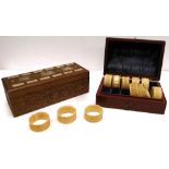 A carved Oriental box set with carved panels of ivory containing a number of draughts and a cased