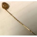 An Edwardian 9ct gold stick pin with horses hoof finial.