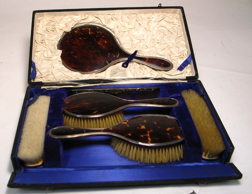 A cased George VI hallmarked silver and tortoise shell hair brush,