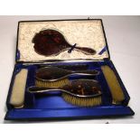A cased George VI hallmarked silver and tortoise shell hair brush,