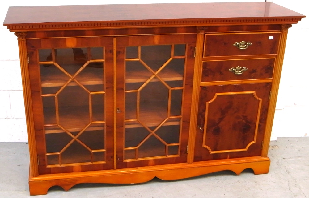 A reproduction astral glazed mahogany cabinet with two interior shelves to one side and two drawers