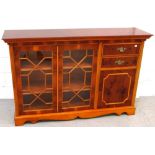 A reproduction astral glazed mahogany cabinet with two interior shelves to one side and two drawers