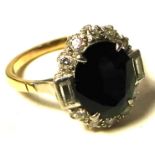 A 9ct gold ring set with large central blue stone and diamond surround, size M, approx weight 4g.