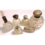 A small hallmarked silver and glass dressing table pot and five perfume bottles with hallmarked