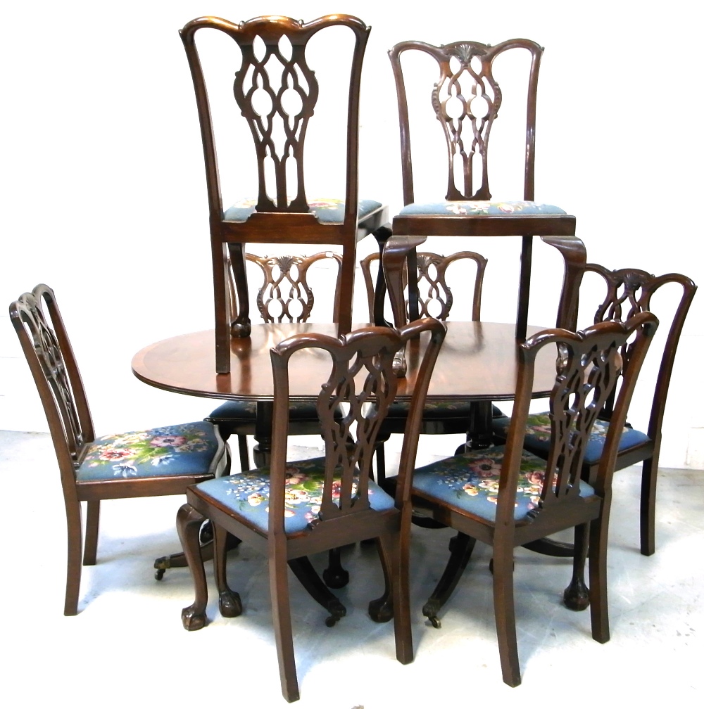 A set of eight mahogany dining chairs with blue ground florally upholstered seat pads and