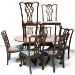 A set of eight mahogany dining chairs with blue ground florally upholstered seat pads and