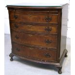 A bow front four drawer walnut chest of drawers of small proportions on shell knee carved squat