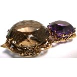 A yellow metal framed amethyst colour stone and topaz colour stone.