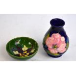 A small Moorcroft baluster vase in "Magnolia" pattern on a blue ground, height 13.5cm, and a