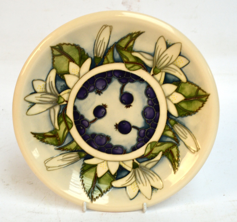 A small modern Moorcroft charger in "Juneberry" pattern, designed by Anji Davenport, with