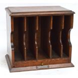 An Edwardian oak five division telegram box with slide above plinth base, set with engraved plaque,