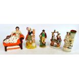 Five late 19th century Staffordshire figures including one spill vase with a boy feeding a dog,