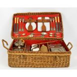 A vintage wicker four setting picnic hamper, comprising plates, cups and saucers (one cup