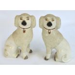 An opposing pair of late 19th century Staffordshire salt glazed spaniels with detached legs and