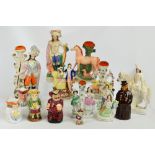 Seven Staffordshire flatback figures including "Forester" and spill vases, and another example,