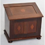 A mahogany and inlaid box with sloping hinged lid raised on four turned bun feet, height 50.5cm,