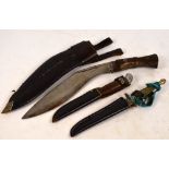 A Gurkha's kukri knife and two daggers in scabbards (3).