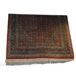 A Hamadan rug with three central conjoined lozenge shaped medallions within a device set main panel