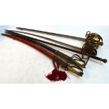 A decorative basket hilt dress sword, two similar brass curved swords in velvet scabbards,