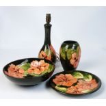 Four pieces of Moorcroft in "Pink Hibiscus" pattern on green ground; a vase of ovoid form,