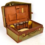 A Finnigans leather gentleman's vanity case with fitted interior containing four George V hallmarked