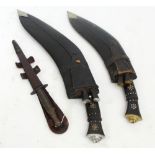 A kukri knife with horn handle and leather scabbard containing two smaller knives, length 51.