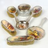 A seven piece hallmarked silver mounted dressing table set, each piece set with a hand painted Royal
