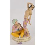 A Royal Dux figure group of an Oriental dancer and a man playing a flute, on oval base, with