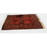 A Bokhara rug with twin central square section medallions within a lozenge shaped main frame and