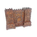 An unusual late 19th century carved oak Black Forest jewellery box modelled as a castle, the central