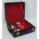 A rectangular travelling drinks box with various glasses and aperture for bottles, width 35cm.