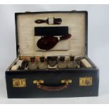 An early 20th century French leather mounted and silk lined travelling vanity case housing