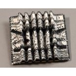 LISA BIRD; a concertina paper brooch, black and white design, length 7.5cm.